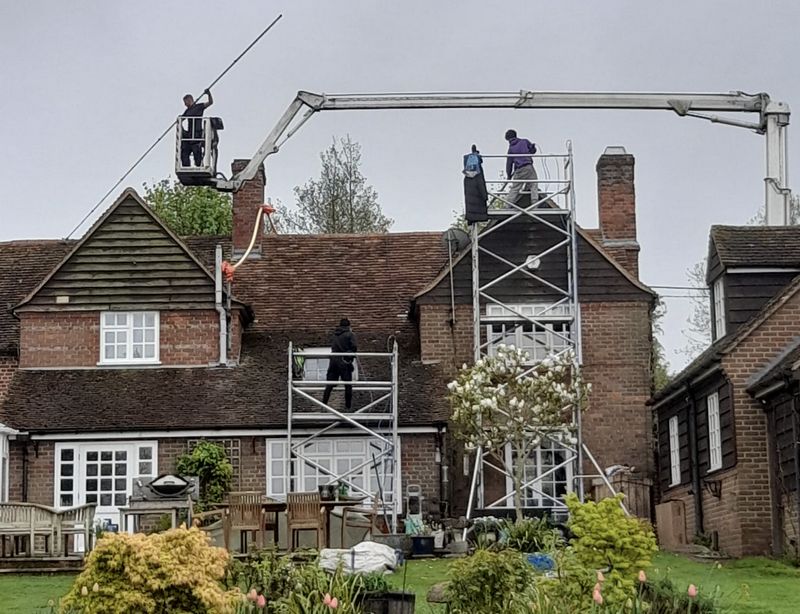 The Roof Moss Cleaners using cherry picker and scaffolding to clean roof safely and professionally in Ampthill, Bedfordshire